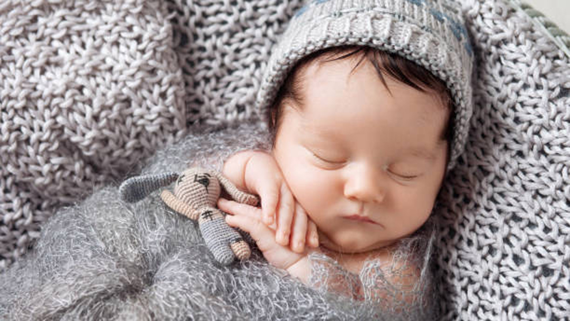 Baby Is Sleeping With Toy Wearing Woolen Knitted Cap HD