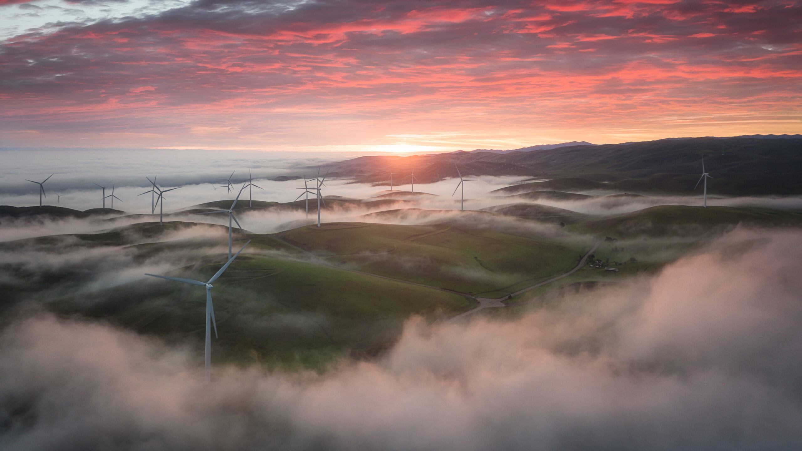 Wind Turbine With Fog And Mountains Under Red Black Clouds Sky During Sunset K HD Nature