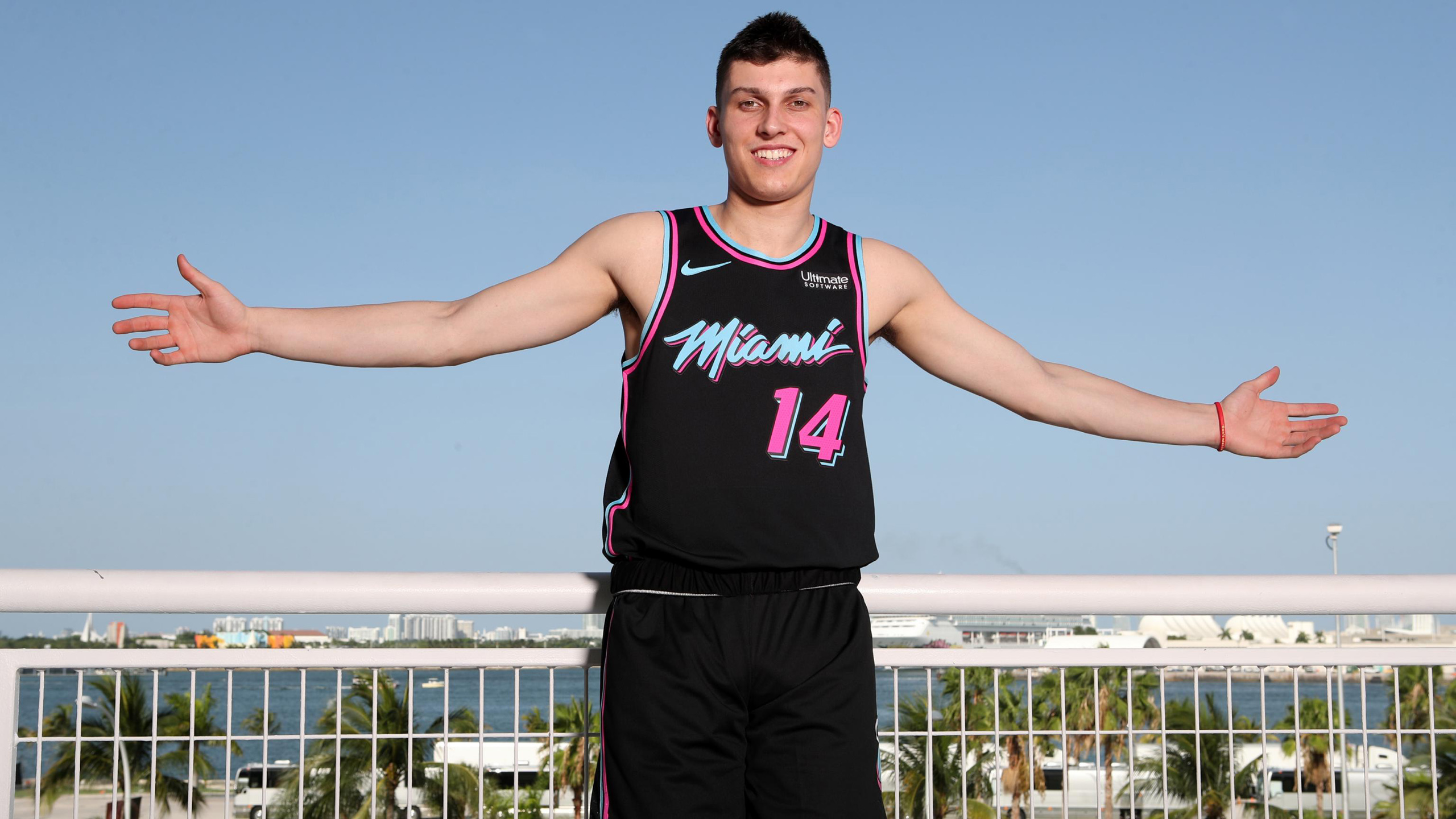 Smiley Cute Tyler Herro Is Showing Hands In The Air Wearing Black Dress While Posing For A Photo In A Scenery Wallpaper Basketball HD