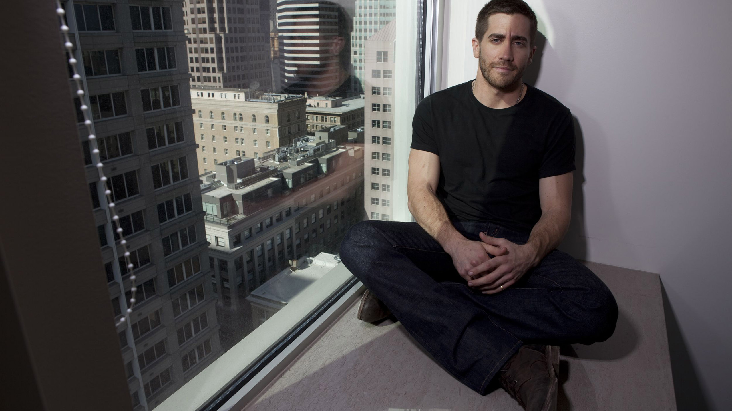 Jake Gyllenhaal Is Leaning On Wall Sitting On Table Wearing Black Dress HD